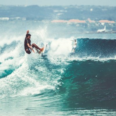 Men and girls surf the island of Bali